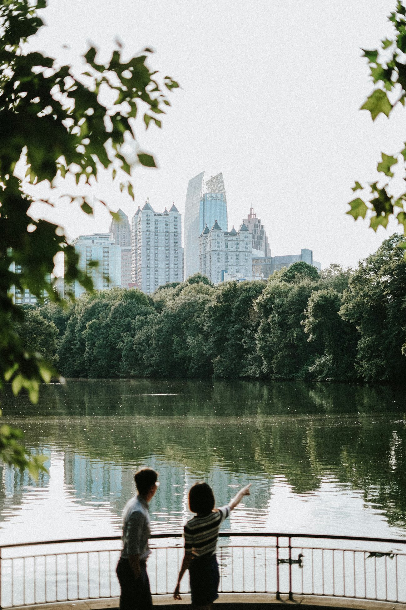 The Extra Mile, Aug. 3: Endangered Points Deals, Absurd Airfare & More 3 photo of two people pointing at a lake with a skyline in background