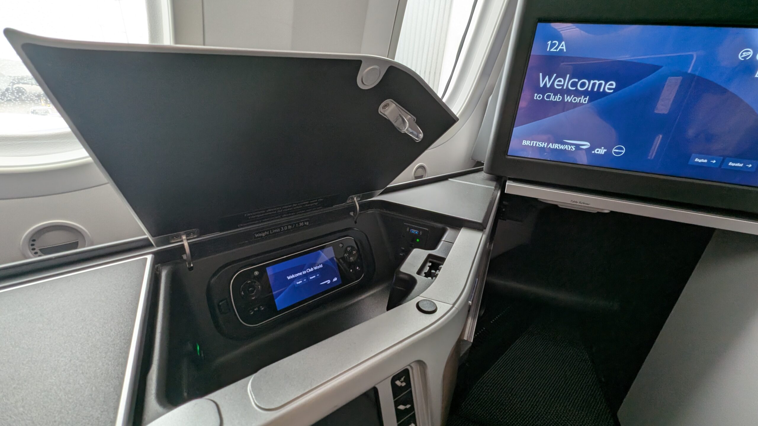 Fine ... But Mostly Forgettable: British Airways Club Suites Review on the Boeing 787-10 30 Storage compartment and remote in BA Club Suites