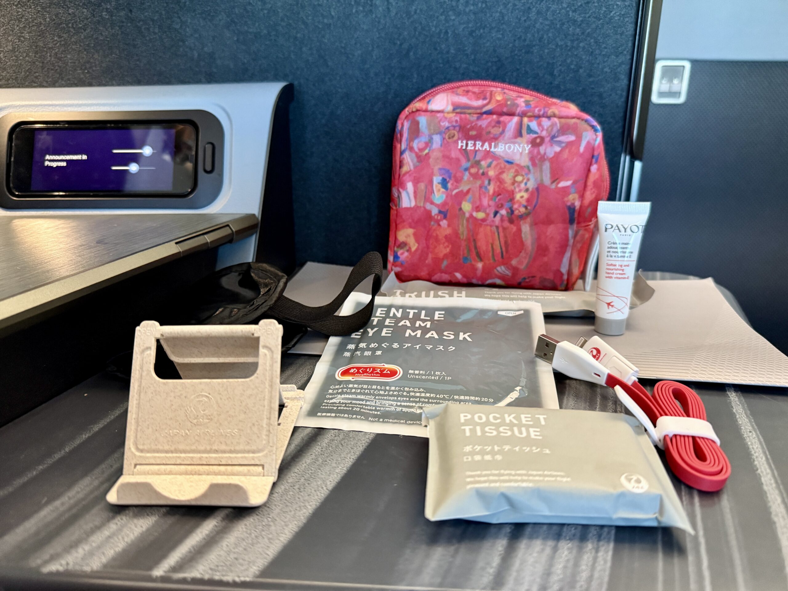 A 5-Star Flight to Tokyo: JAL's New A350 Business Class Suites 66 contents of business class amenity kit spread on seat table