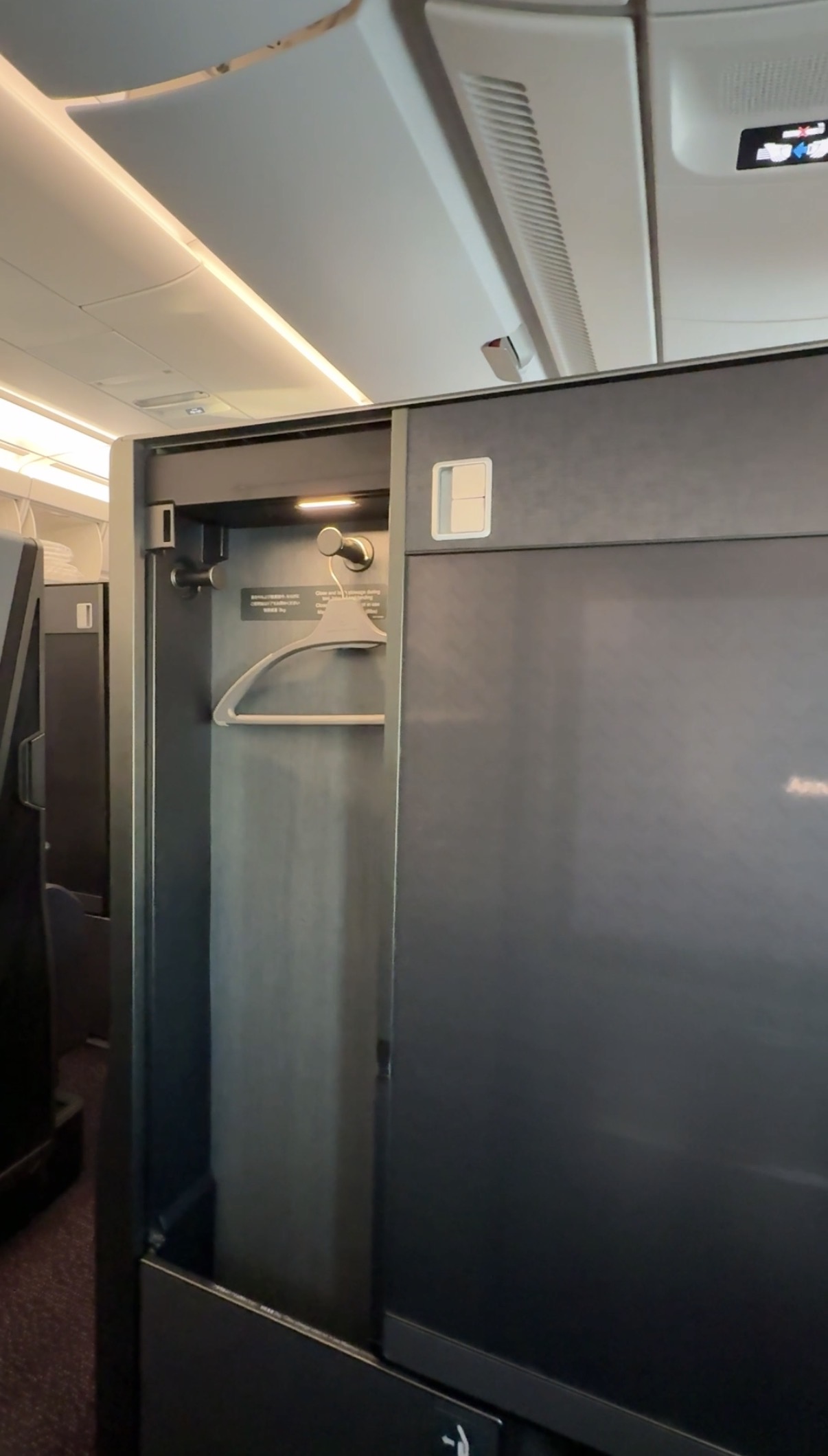 A 5-Star Flight to Tokyo: JAL's New A350 Business Class Suites 57 closet with hanger inside of door on plane