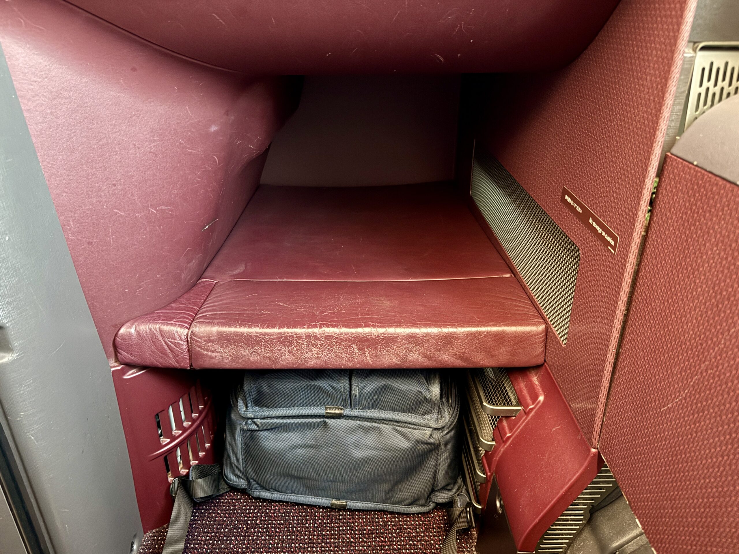 A 5-Star Flight to Tokyo: JAL's New A350 Business Class Suites 56 japan airlines footwell with a backpack underneath it