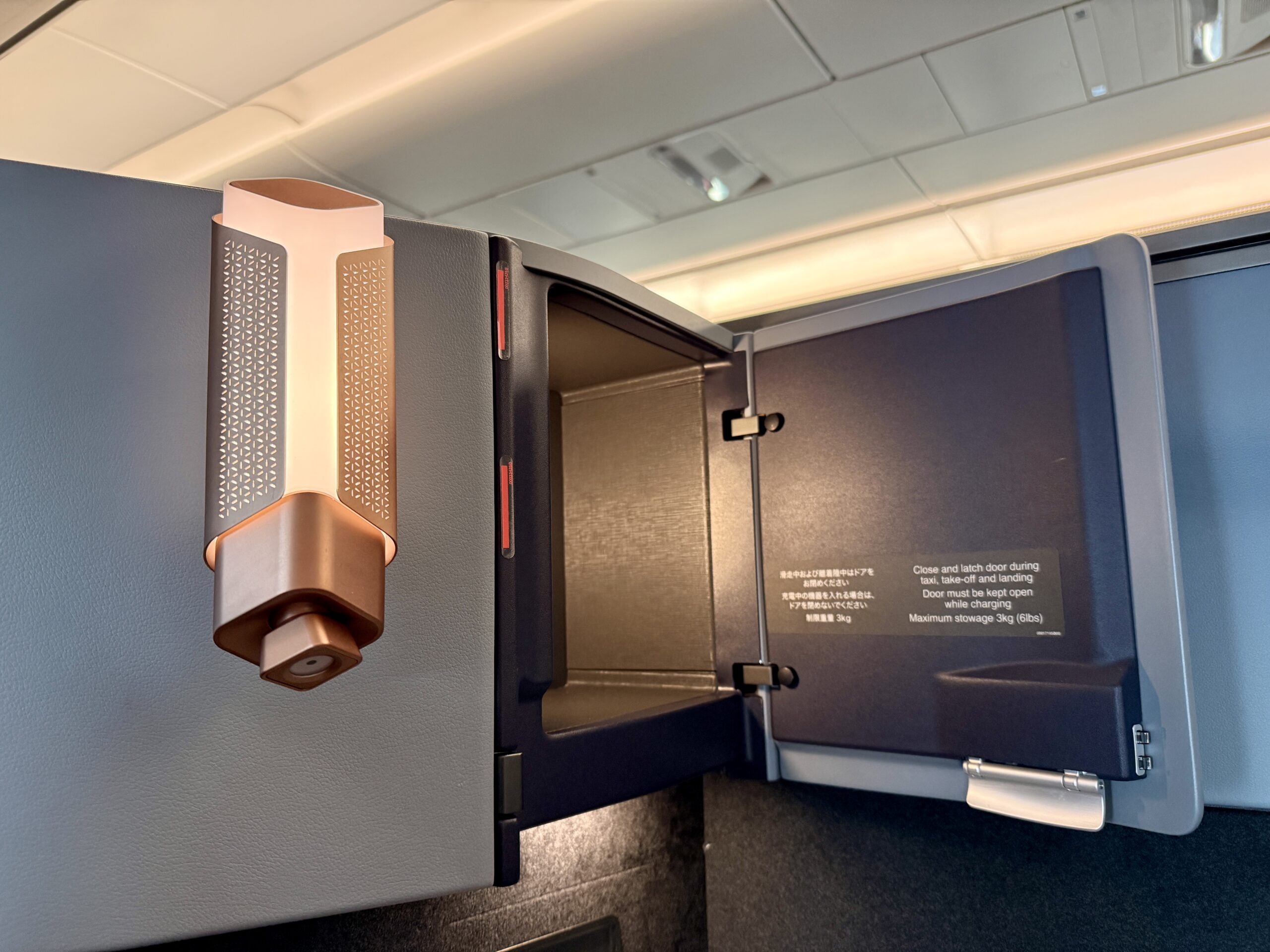 A 5-Star Flight to Tokyo: JAL's New A350 Business Class Suites 60 lamp on seatback wall with open storage compartment