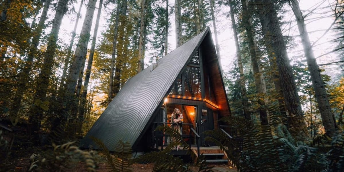 The Extra Mile, Oct. 26: Amex Cracks Down on 'Rewards Maxers' + The New Best Card for Booking Airbnb? 1 An A-frame cabin glowing among tall trees and ferns